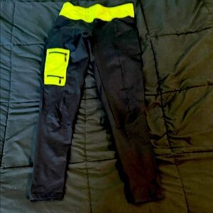 Women’s Black and Neon Green leggings by Bebe